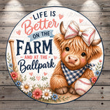 a cute, furry cow wearing a baseball hat and a checkered bandana, sitting next to a baseball and surrounded by flowers.
