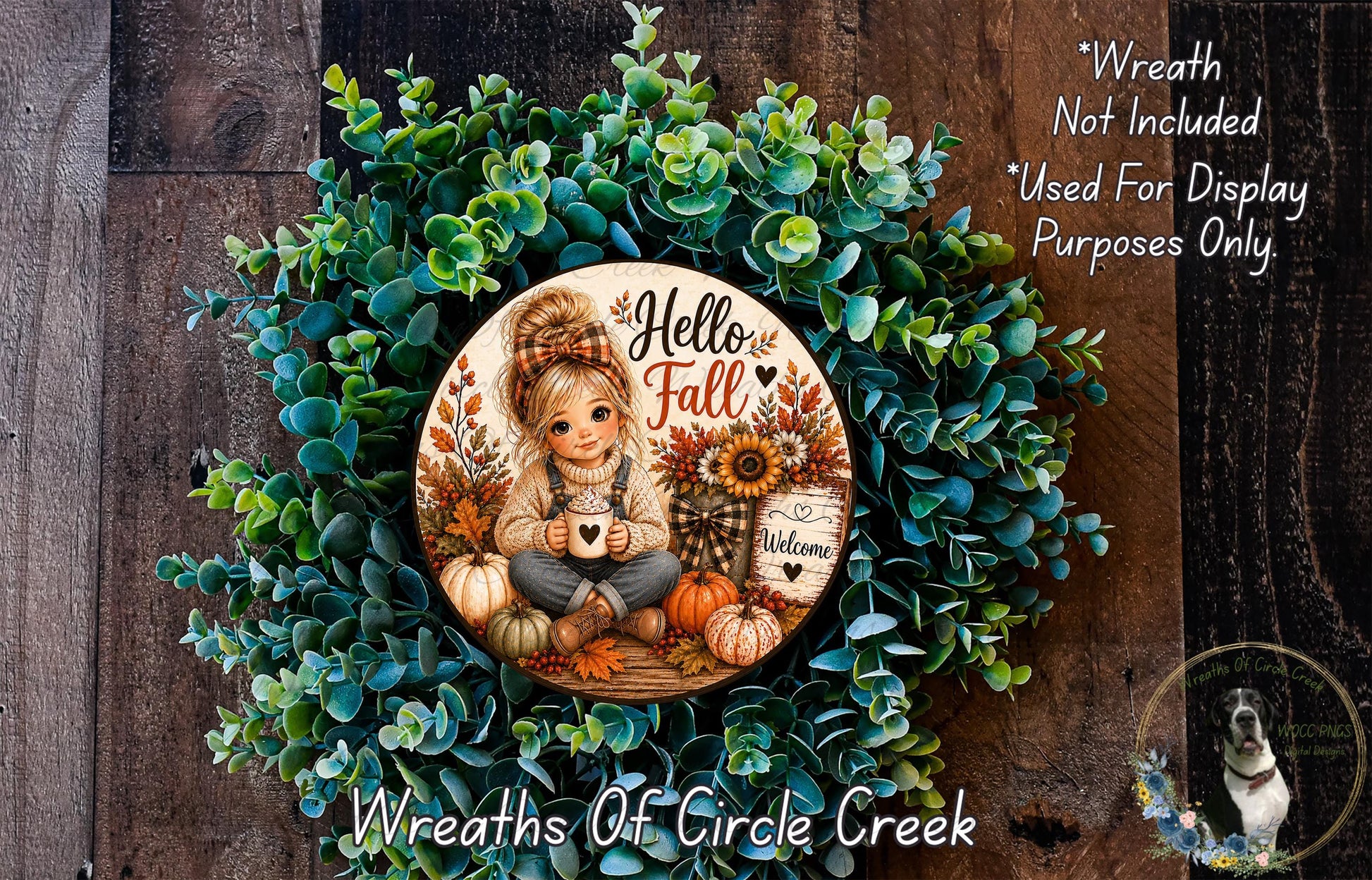 A wreath made of green leaves and autumn-themed decorations, including a girl holding a coffee mug and a sign that says "Welcome".