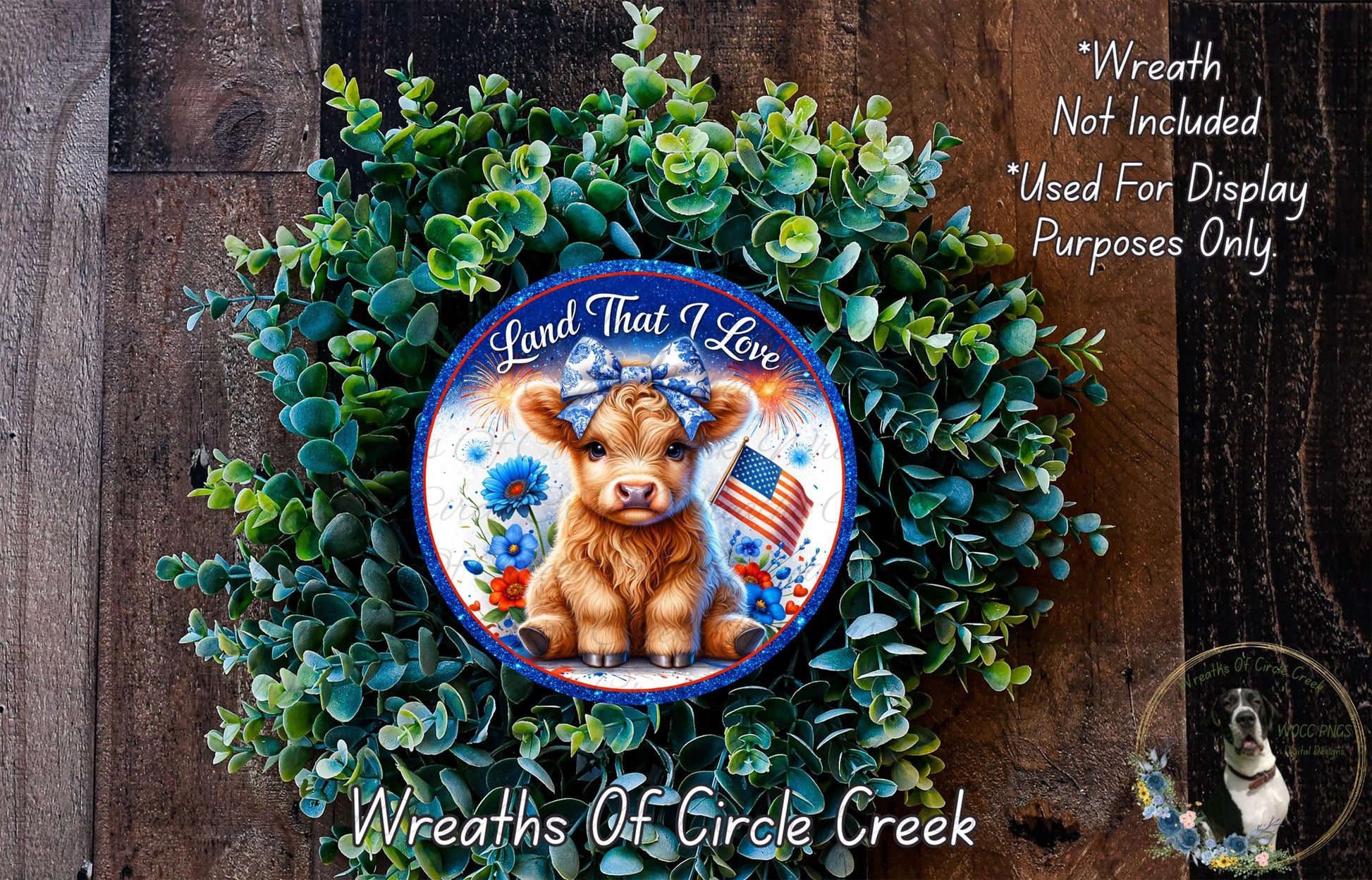 a wreath with a cow and an American flag, surrounded by greenery. The wreath is displayed on a wooden surface.