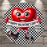 A red heart-shaped character holding a banner that says "Happy Valentine's Day" against a black and white checkered background.