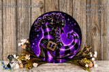 a large, purple and black striped shoe with a gold buckle, surrounded by a wreath of flowers and a wooden background.