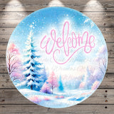 A circular winter scene with a snowy landscape, pine trees, and a "Welcome" message in pink cursive text.