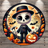 A spooky skeleton wearing a top hat and holding a pumpkin, surrounded by bats, flowers, and a full moon, all set against a wooden background.