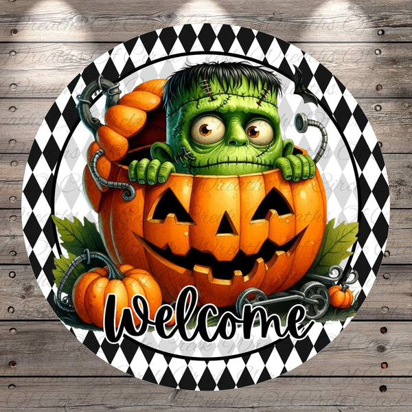 A Halloween-themed illustration featuring a green monster with a pumpkin face peeking out from a carved jack-o-lantern. The monster appears to be in a creepy or evil mood, and the word "Welcome" is written below the jack-o-lantern.