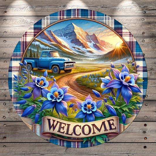 A blue pickup truck is driving down a dirt road surrounded by a colorful floral border, with a mountain range and sunset in the background. The word "WELCOME" is prominently displayed in the center of the image.