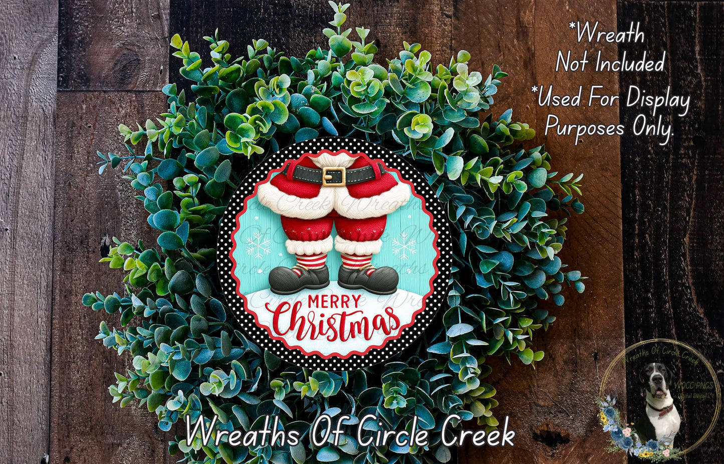 A Christmas wreath made of green foliage and featuring a Santa Claus figure in a red suit, with the text "Merry Christmas" displayed on the wreath.