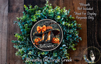 A Halloween wreath made of green foliage and featuring a black and orange witch's hat with a pumpkin and spider design. The wreath is displayed on a wooden surface, and there is a text overlay that reads "Wreath Not Included * Used For Display Purposes Only" and "Wreaths Of Circle Creek".