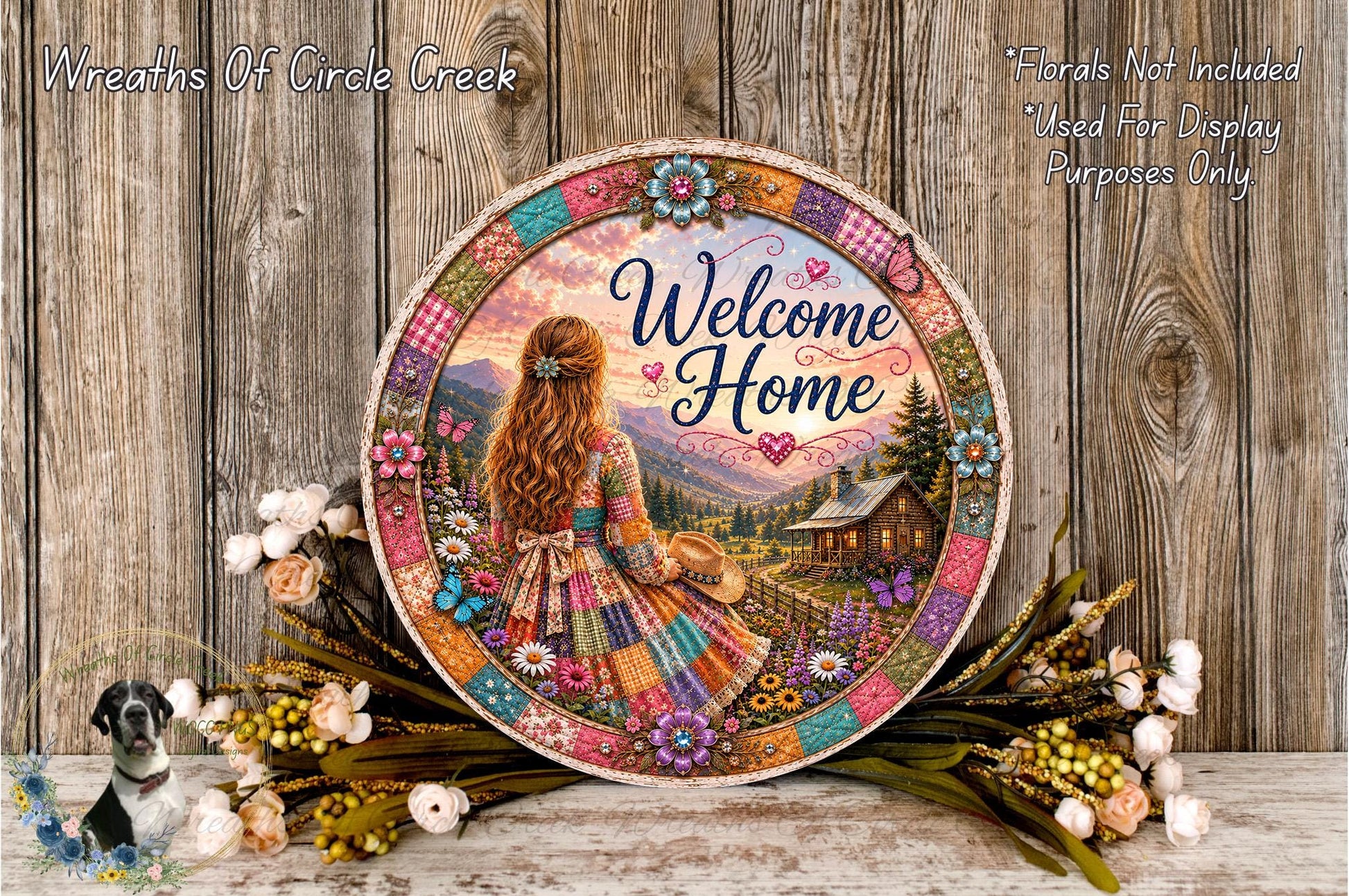 a decorative plate with a colorful, patchwork design depicting a woman in a dress standing in a field with a house in the background. The plate is surrounded by flowers and placed on a wooden surface.