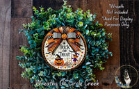 a wreath with a trick or treat on it