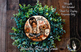 A wreath made of green leaves and flowers, with a central image of a young girl sitting and holding a coffee mug. The wreath is surrounded by text that reads "Hello Fall Welcome" and "Wreaths of Circle Creek".