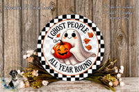 a Halloween-themed sign with a ghost holding a pumpkin, surrounded by flowers and a wooden background.