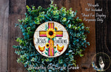 a wreath with a cross and flowers on it