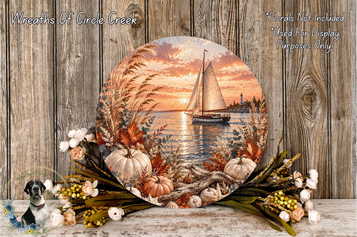 a round, decorative plate with a painting of a sailboat on a body of water, surrounded by autumn foliage and pumpkins, set against a wooden background.