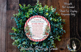 A wreath made of green leaves and a red and white circular sign that says "12 DAYS OF CHRISTMAS AT THE BEACH".