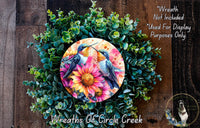 a picture of two birds on a flower wreath