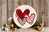 a round wooden plaque with a heart design, surrounded by flowers and foliage.