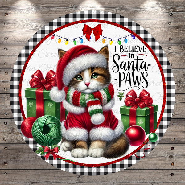 A cat wearing a Santa hat and scarf, surrounded by Christmas decorations such as presents, ornaments, and lights, with the text "I Believe in Santa Paws" displayed.