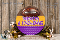 a round wooden sign with a football on it, surrounded by a wreath of flowers and greenery. The sign has the text "tailgates & touchdowns" written on it.