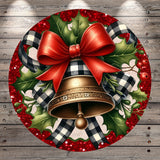 A festive Christmas wreath with a large red bow, a golden bell, and red berries, all set against a wooden background.