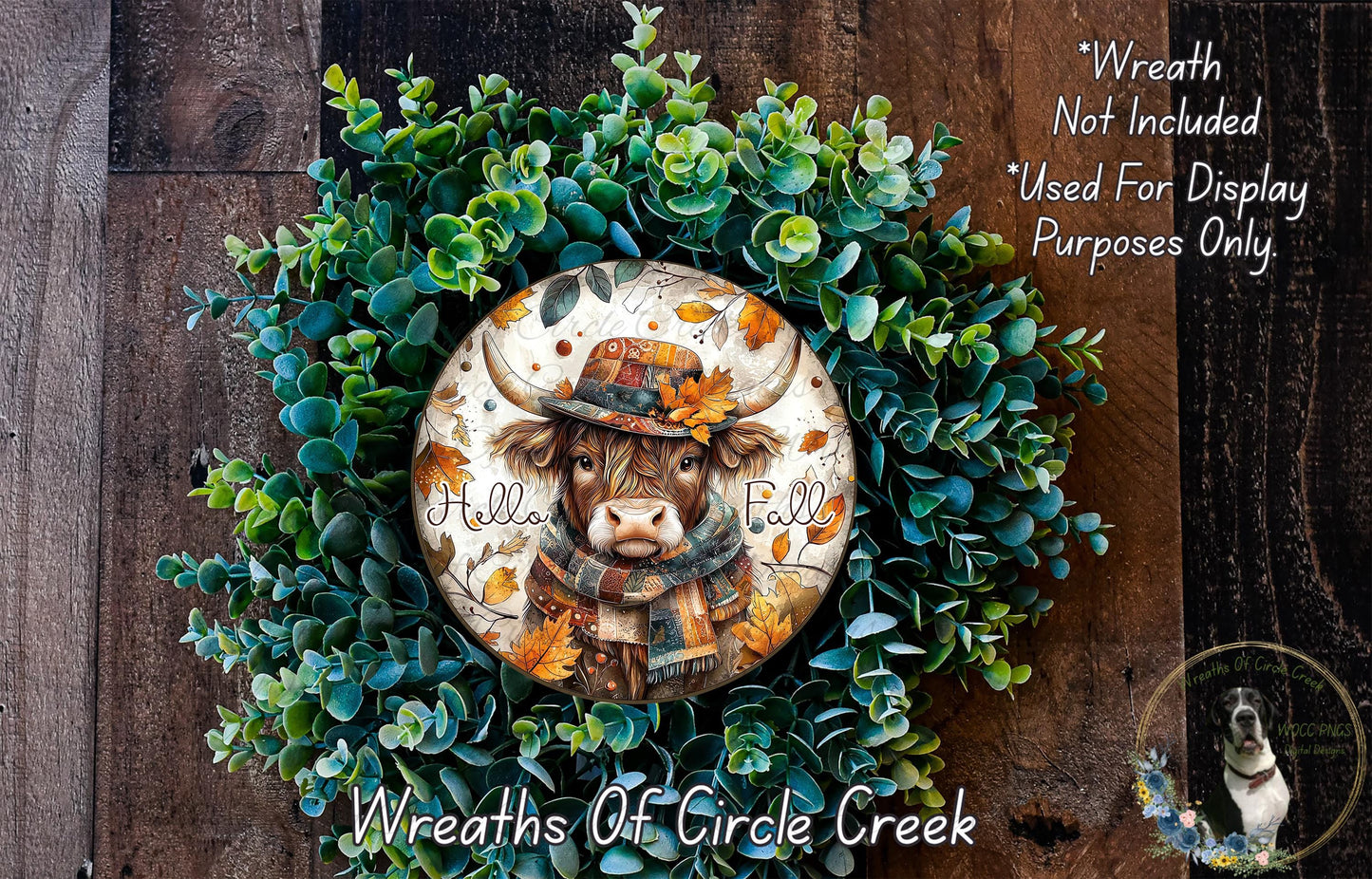 A wreath made of green leaves and a cow wearing a hat, with the text "Hello Fall" written on it.