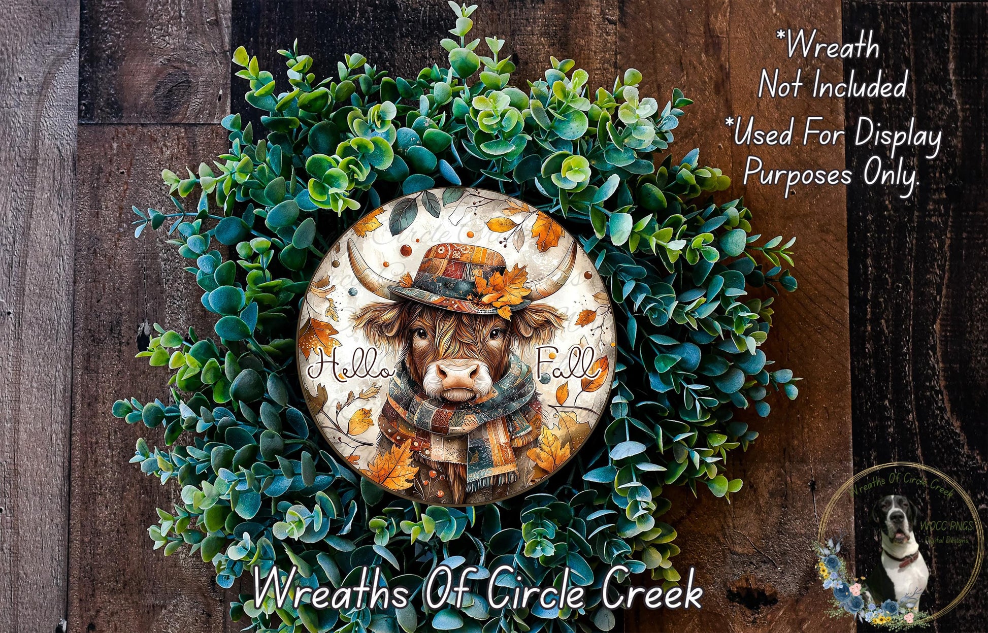 A wreath made of green leaves and a cow wearing a hat, with the text "Hello Fall" written on it.