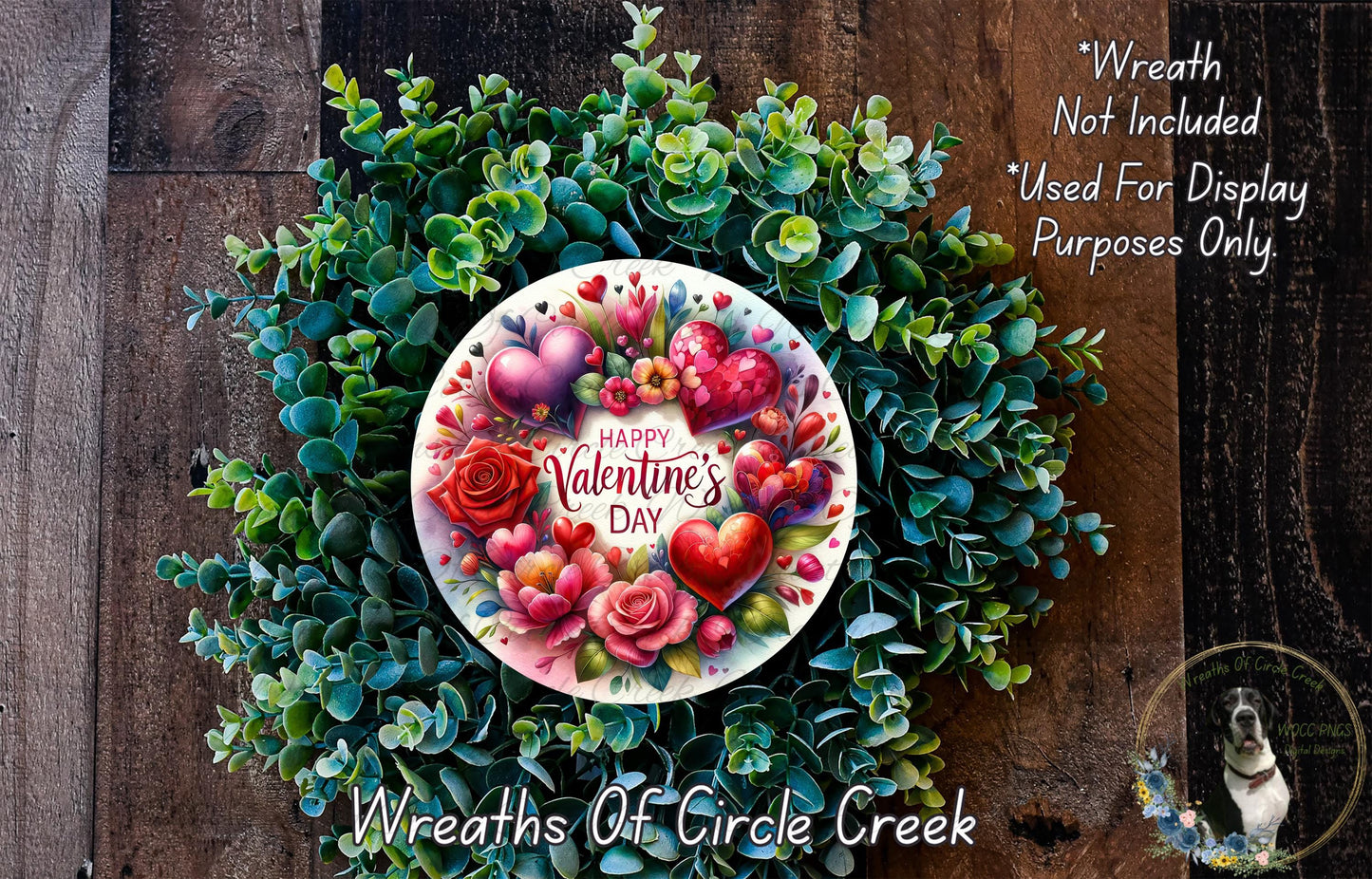 A wreath made of green leaves and flowers, with a white plate in the center displaying a "Happy Valentine's Day" message surrounded by hearts and flowers.