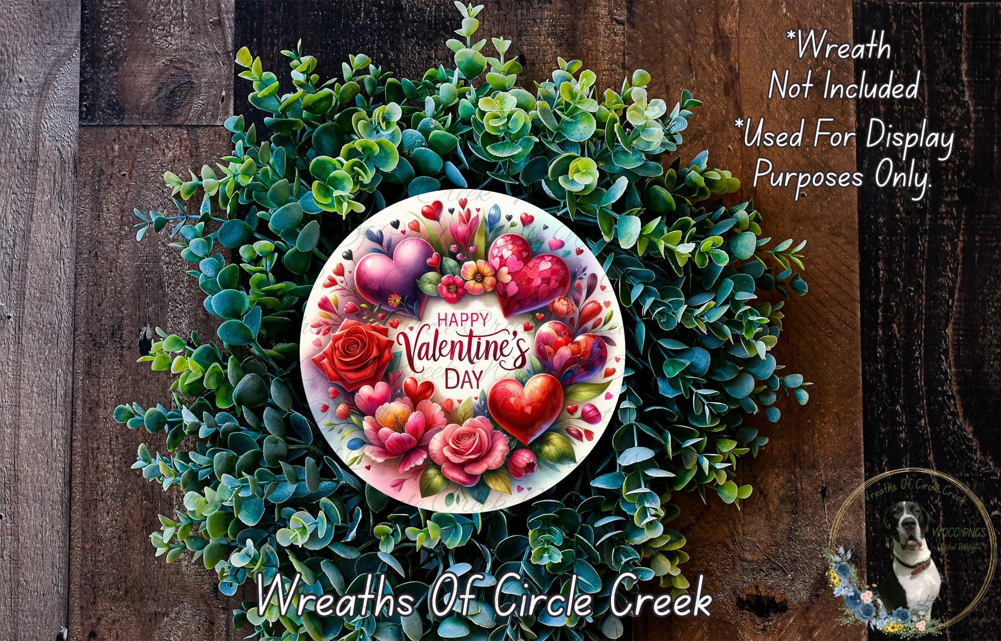 A wreath made of green leaves and flowers, with a white plate in the center displaying a "Happy Valentine's Day" message surrounded by hearts and flowers.