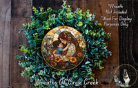 a wreath with a stained glass-style depiction of a woman holding a child, surrounded by green foliage. The wreath is placed on a wooden surface, and there is a small dog visible in the bottom right corner of the image.