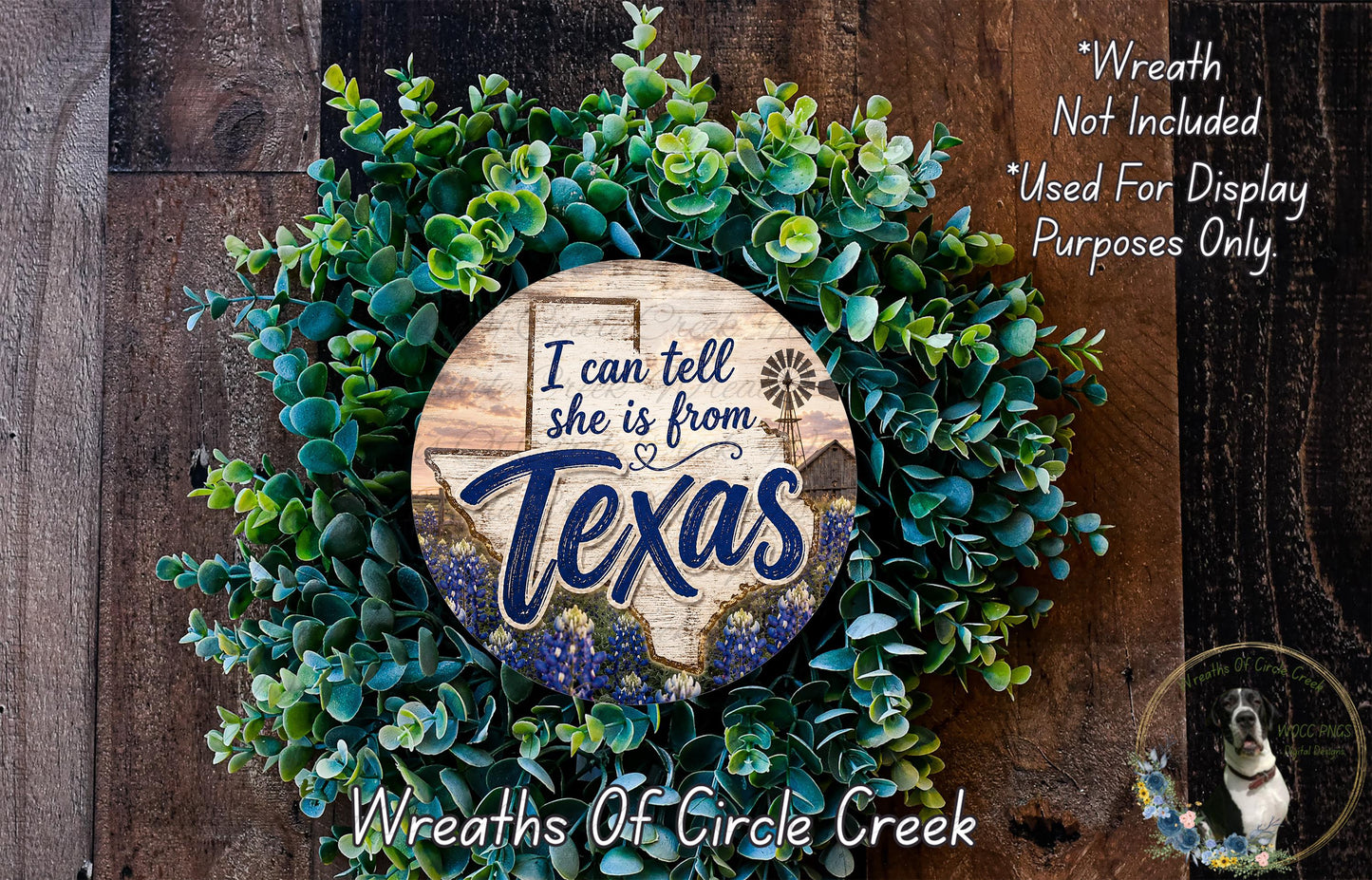 a wreath made of green leaves and a wooden sign with the text "I can tell she is from Texas" surrounded by a wooden background.