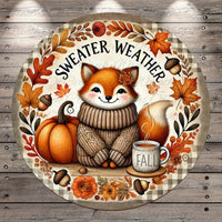 A round, decorative plate featuring a cartoon fox wearing a sweater and surrounded by autumn-themed elements such as leaves, pumpkins, and a cup of coffee.