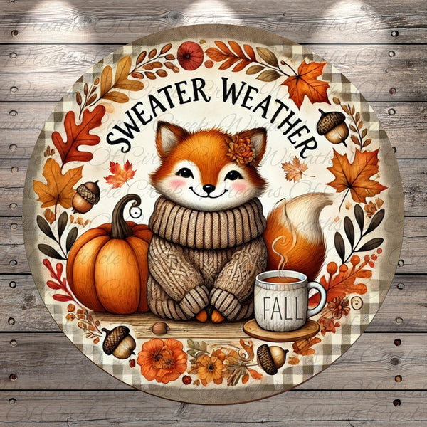 A round, decorative plate featuring a cartoon fox wearing a sweater and surrounded by autumn-themed elements such as leaves, pumpkins, and a cup of coffee.