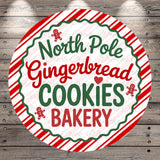 A circular sign with the text "North Pole Gingerbread Cookies Bakery" written in a festive, holiday-themed font.