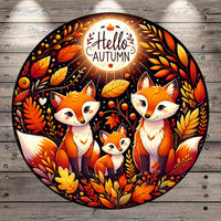 A vibrant illustration featuring three cartoon foxes surrounded by autumn foliage, including leaves, berries, and a glowing moon. The text "Hello Autumn" is prominently displayed above the foxes.