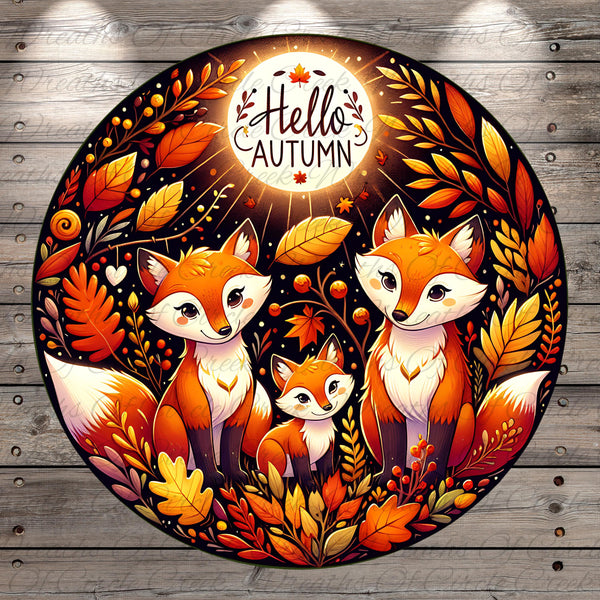 A vibrant illustration featuring three cartoon foxes surrounded by autumn foliage, including leaves, berries, and a glowing moon. The text "Hello Autumn" is prominently displayed above the foxes.