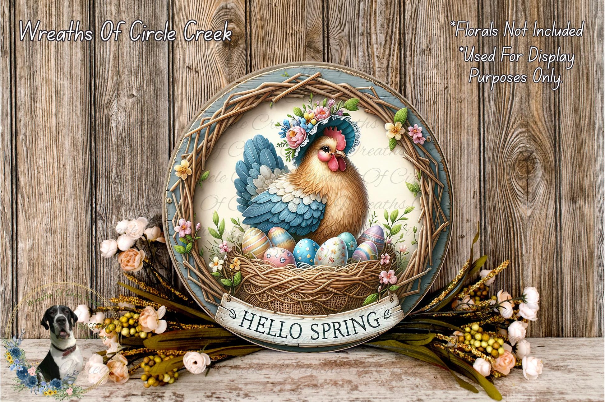 A decorative Easter wreath with a rooster and eggs, surrounded by flowers and greenery, placed on a wooden surface.