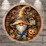 A gnome wearing a straw hat and overalls sits next to a carved jack-o-lantern, surrounded by autumn decorations such as sunflowers, leaves, and a "Welcome Fall" sign.