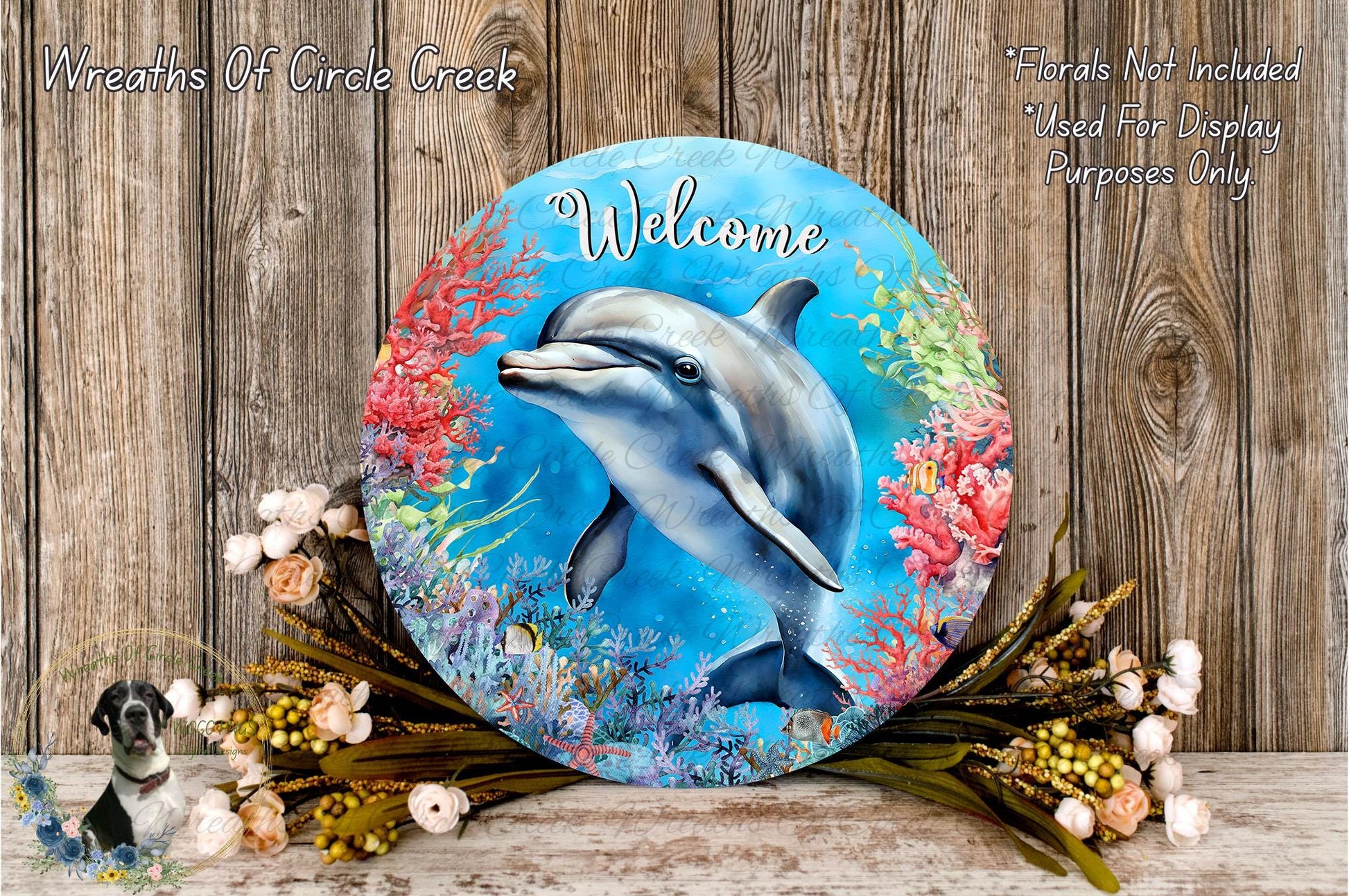 a round sign with a dolphin illustration, surrounded by a colorful underwater scene with coral and flowers. The sign has the word "Welcome" written on it.