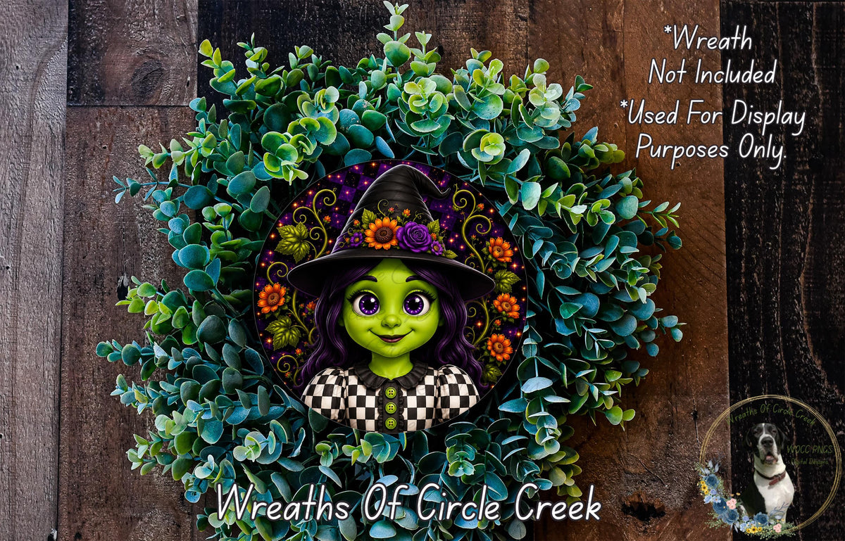 A wreath featuring a cartoon character with purple hair and a witch's hat, surrounded by green foliage.