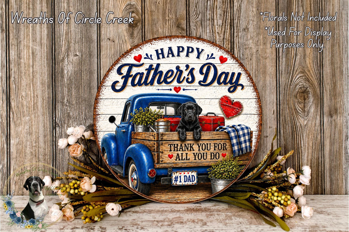 A round wooden sign with a blue truck and a dog, surrounded by flowers and greenery, with the text "Happy Father's Day" and "Thank you for all you do".