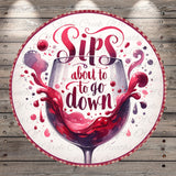 a wine glass with a splash of red wine, accompanied by the text "Sips about to go down" in a decorative font.