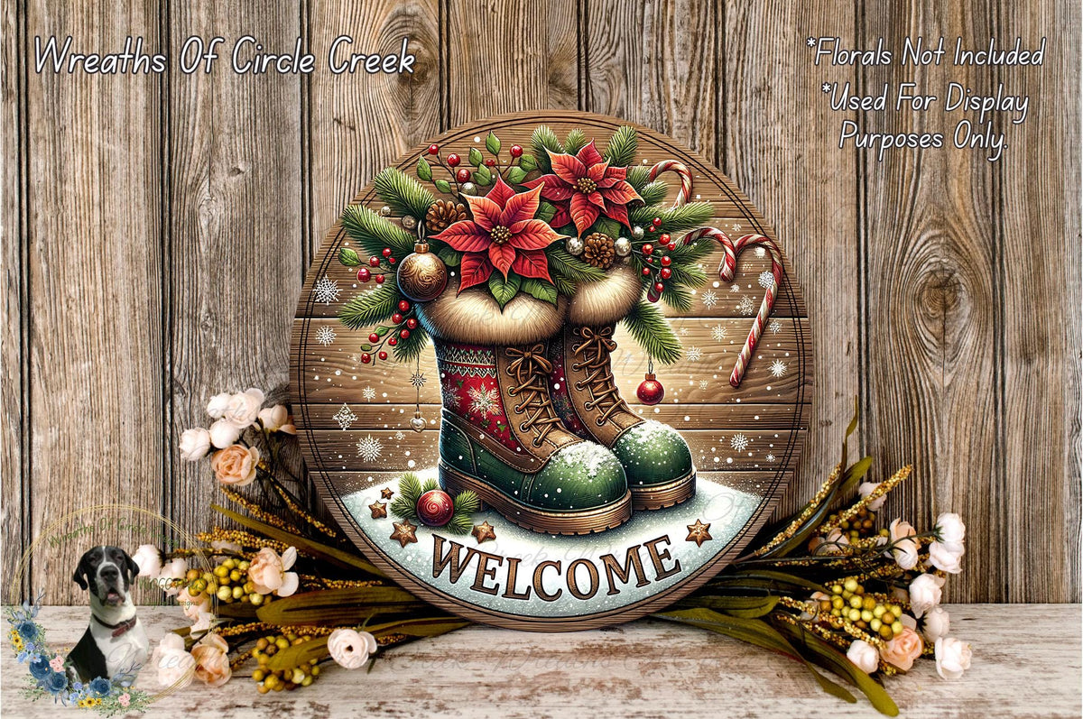A circular wooden sign with a festive design, featuring a pair of boots, poinsettias, and a "Welcome" sign. The sign is surrounded by a wreath of flowers and a candy cane.