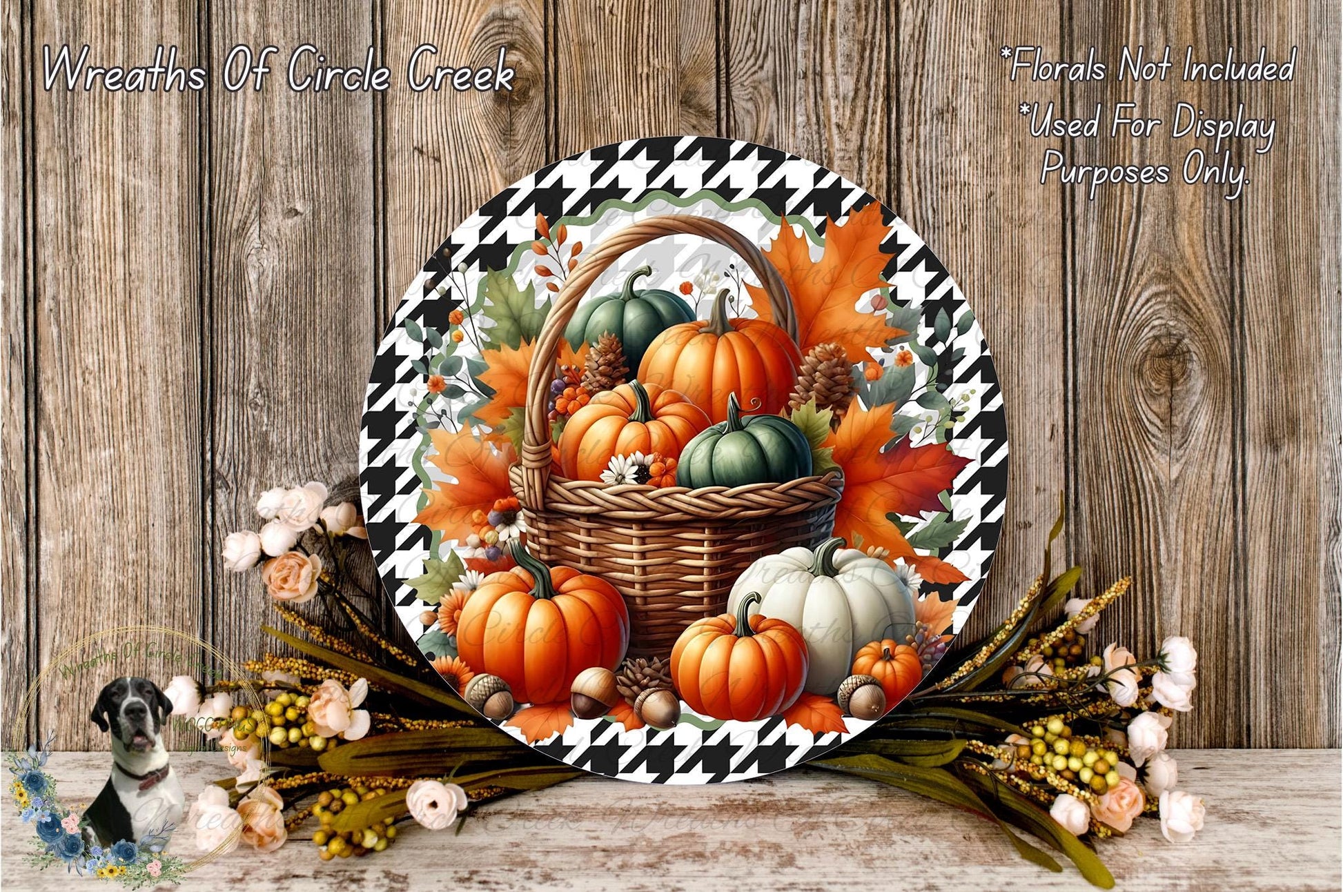 A decorative wreath made of a basket filled with autumn-themed pumpkins and leaves, placed on a wooden surface.