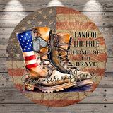 a pair of combat boots with an American flag design, accompanied by the text "Land of the Free Home of the Brave" and "Remember and Honor".