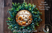 a wreath with a welcome sign, surrounded by various autumn-themed elements such as pumpkins, sunflowers, and greenery.