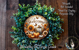 a wreath with a welcome sign, surrounded by various autumn-themed elements such as pumpkins, sunflowers, and greenery.