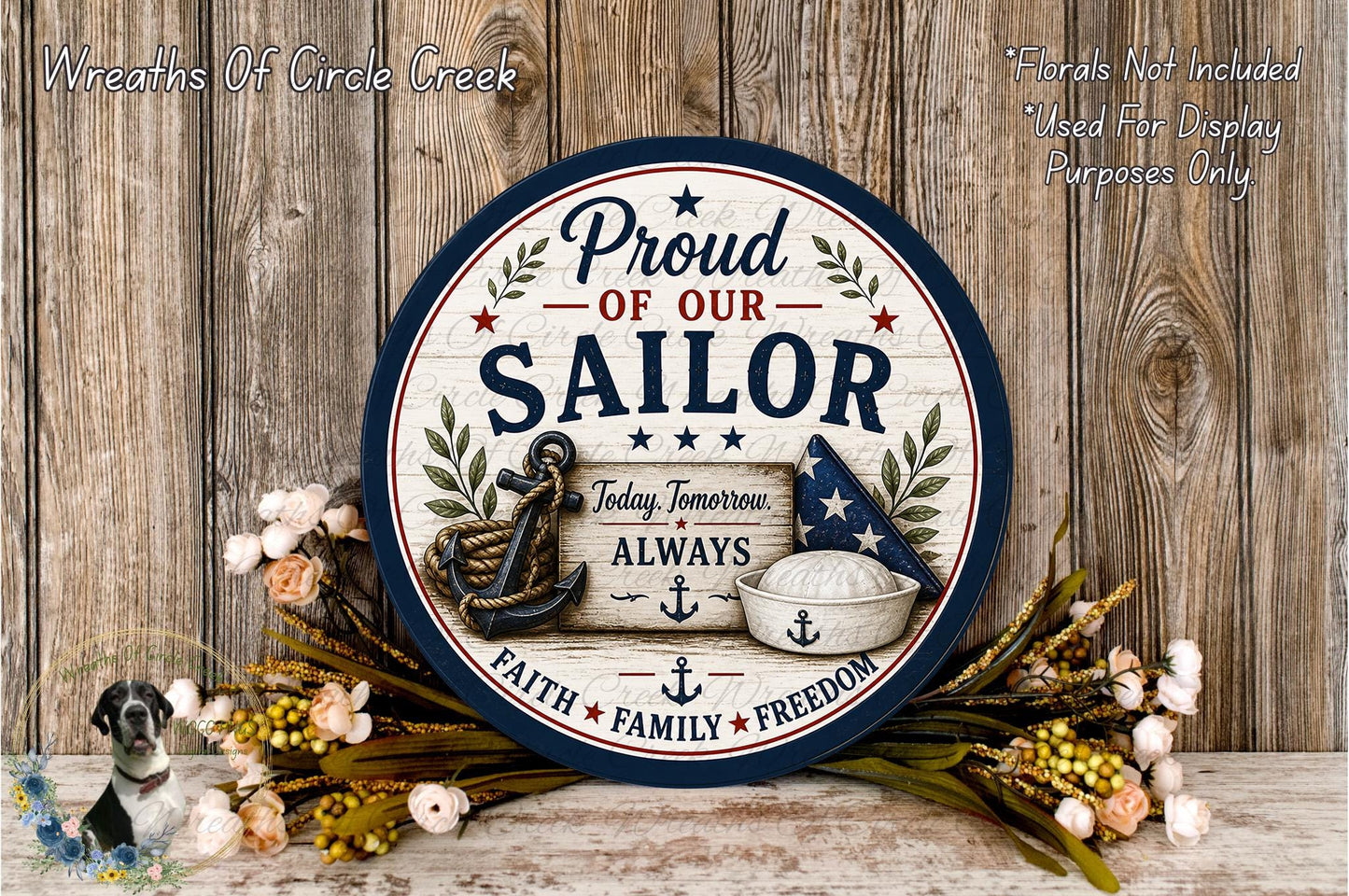 a round sign with the text "Proud of our Sailor" and an anchor, surrounded by flowers and a wooden background.