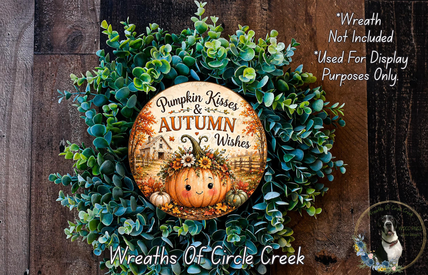 a wreath made of green leaves and a pumpkin with a face, surrounded by a wooden background. The wreath has a circular design with text that reads "Pumpkin Kisses & Autumn Wishes".