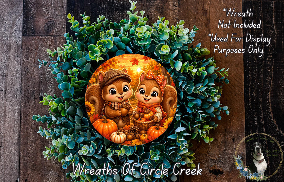 A wreath featuring two cartoon squirrels, one wearing a hat and the other a scarf, surrounded by autumn foliage and pumpkins. The wreath is displayed on a wooden surface, and there is a text overlay that reads "Wreath Not Included * Used For Display Purposes Only".