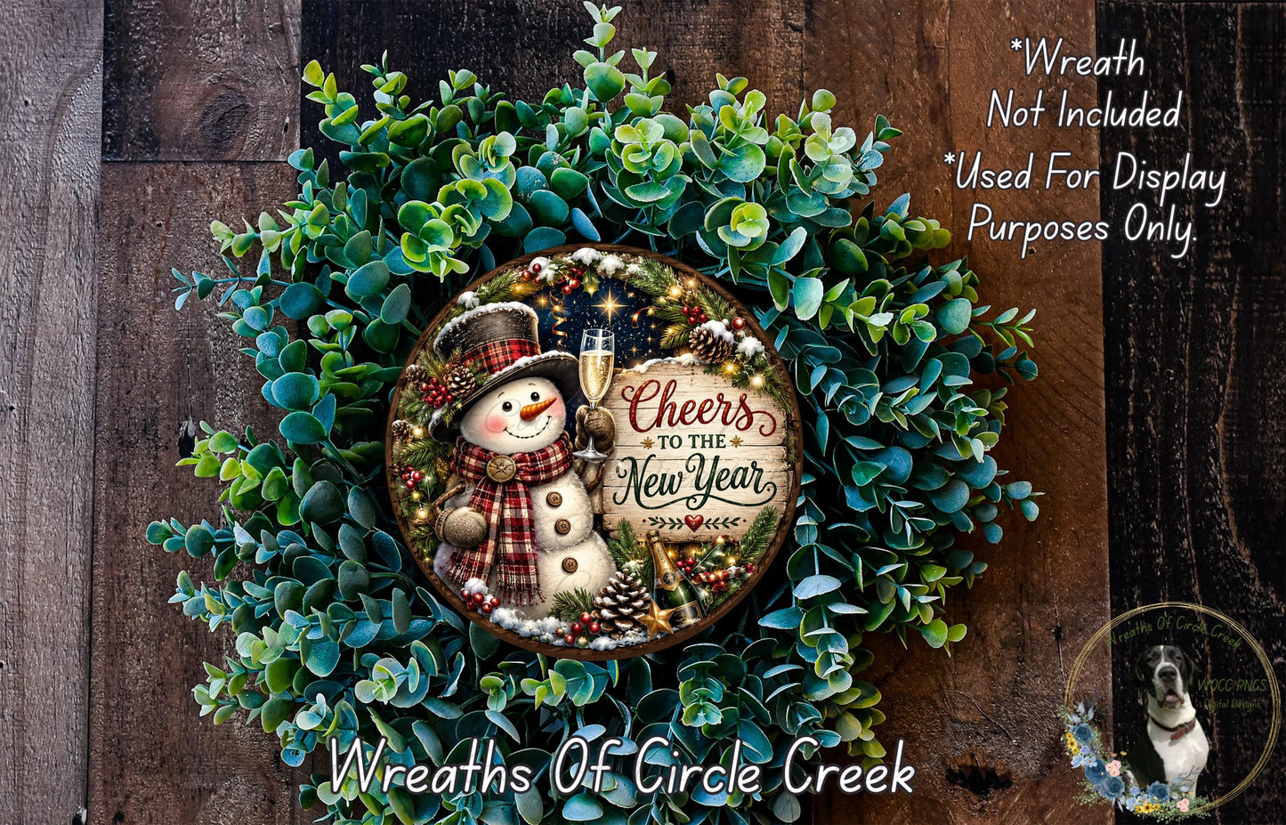 A wreath made of green foliage and featuring a snowman holding a sign that says "Cheers to the New Year".