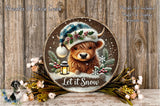 A wooden sign featuring a cartoon cow wearing a winter hat and surrounded by snow, flowers, and a lantern, with the text "Let it Snow" displayed on it.